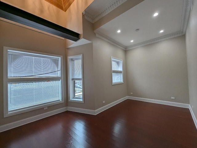 spare room with dark hardwood / wood-style flooring and crown molding