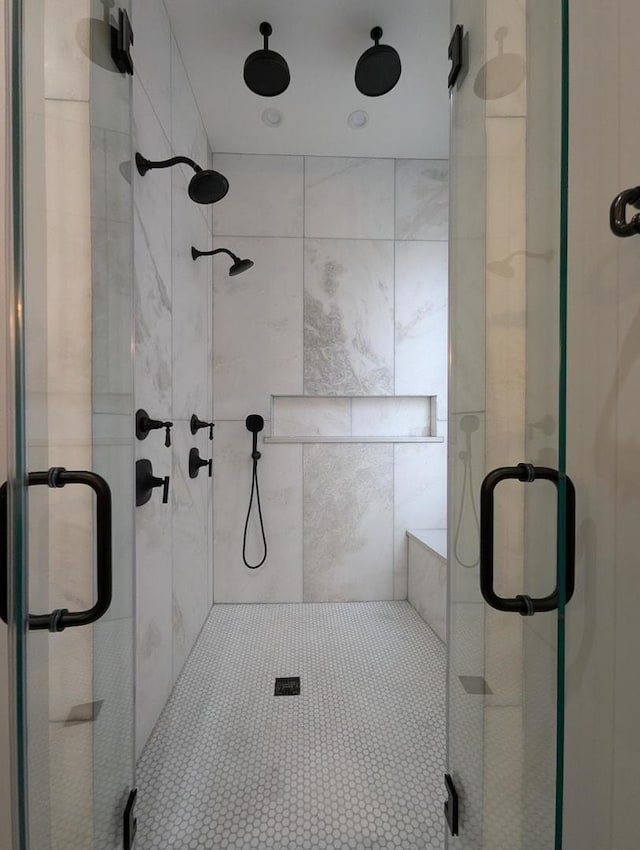 bathroom featuring a shower with shower door