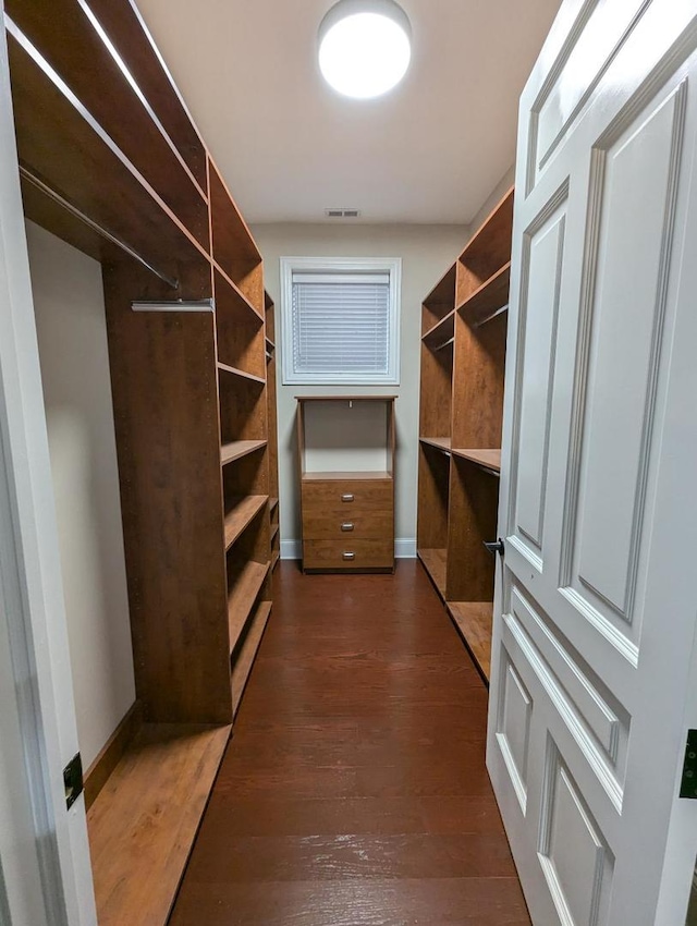 spacious closet featuring dark hardwood / wood-style floors