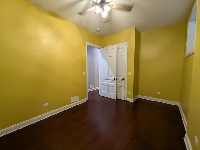 unfurnished bedroom featuring ceiling fan and dark wood-type flooring