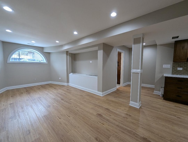 basement with light hardwood / wood-style flooring