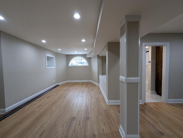 basement with light hardwood / wood-style floors