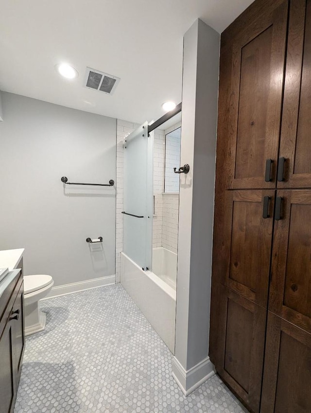 full bathroom featuring vanity, combined bath / shower with glass door, and toilet