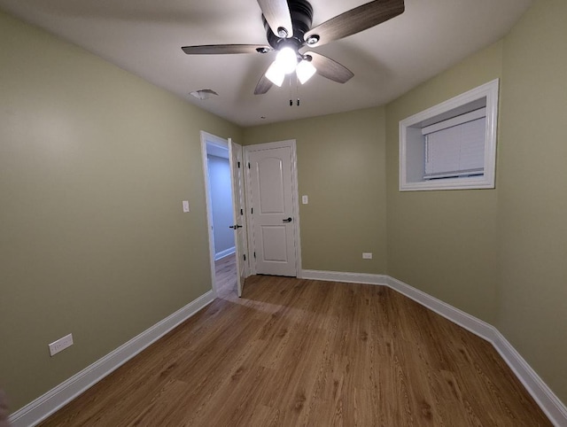 spare room featuring ceiling fan and light hardwood / wood-style flooring