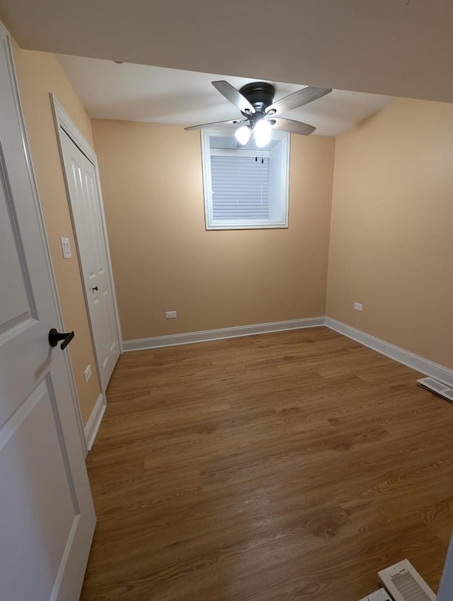 spare room with hardwood / wood-style floors and ceiling fan