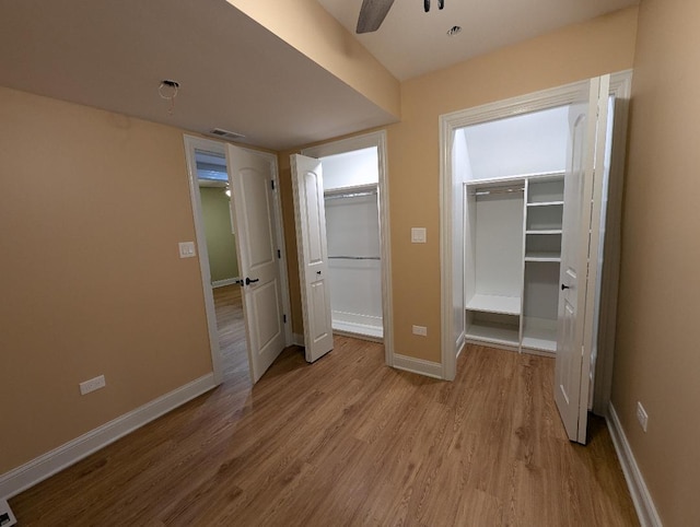 unfurnished bedroom featuring light wood-type flooring and ceiling fan