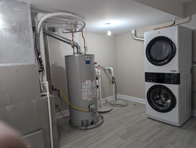 utilities featuring gas water heater and stacked washing maching and dryer