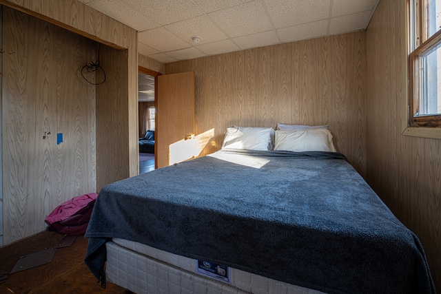 bedroom with wooden walls