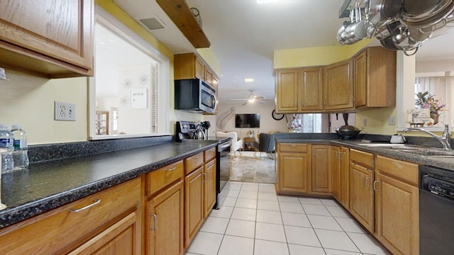 kitchen with appliances with stainless steel finishes, ceiling fan, light tile patterned floors, and sink