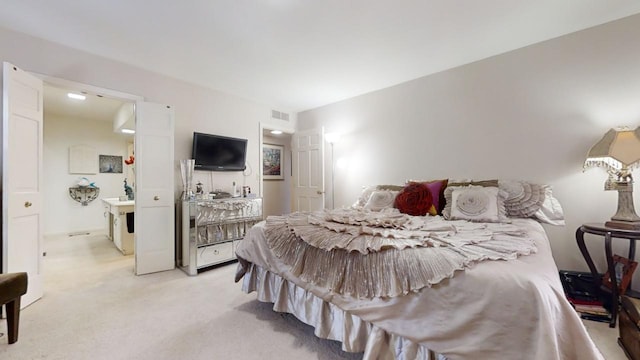 carpeted bedroom featuring ensuite bathroom