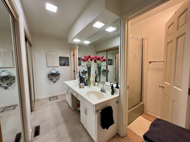 bathroom with enclosed tub / shower combo and vanity