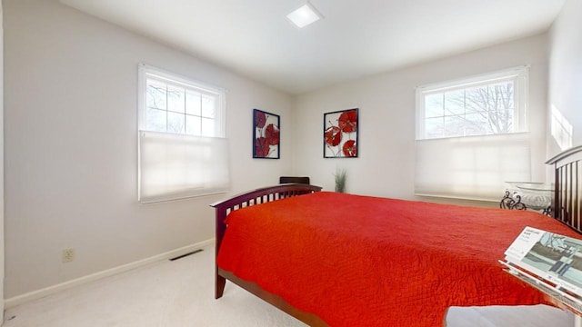 carpeted bedroom featuring multiple windows