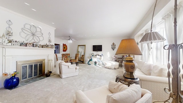 carpeted living room featuring a tile fireplace and ceiling fan