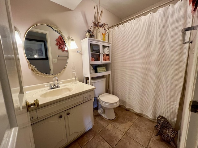 bathroom with toilet, tile patterned flooring, and vanity