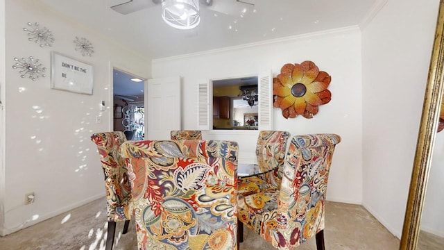 carpeted dining space with ceiling fan and crown molding