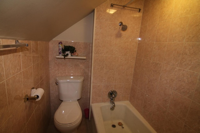 bathroom with tiled shower / bath combo and toilet