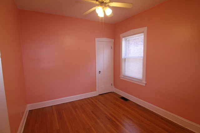 spare room featuring hardwood / wood-style floors and ceiling fan