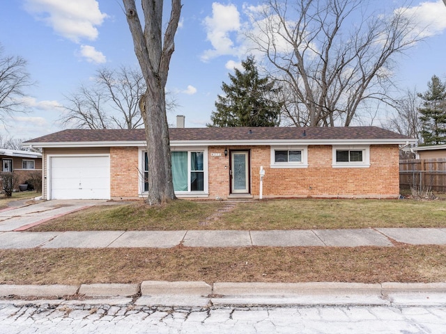 single story home with a garage and a front lawn