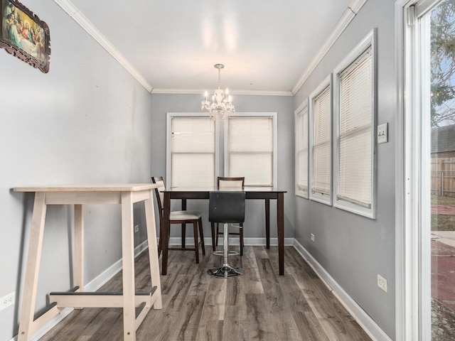 dining space featuring crown molding, a chandelier, and dark hardwood / wood-style flooring