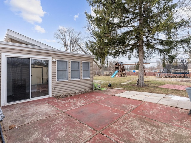 view of patio featuring a playground and a trampoline