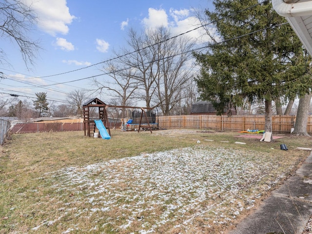 view of yard featuring a playground and a trampoline