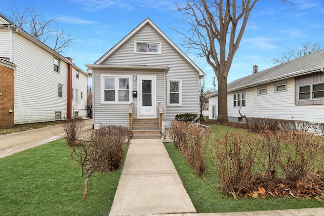 bungalow-style home featuring a front yard