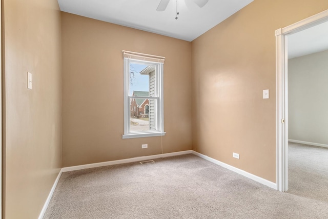 carpeted empty room featuring ceiling fan