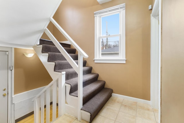 staircase featuring tile patterned flooring