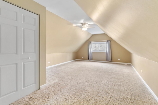 additional living space featuring carpet flooring, ceiling fan, and vaulted ceiling