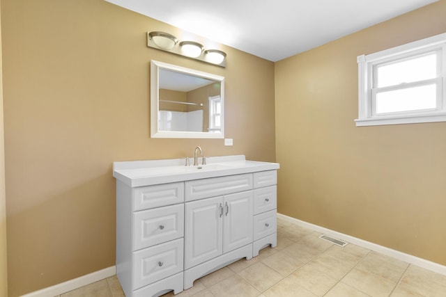 bathroom with tile patterned flooring and vanity