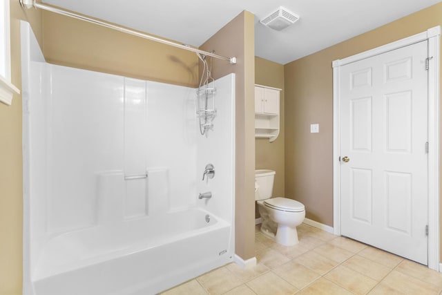 bathroom featuring tile patterned flooring, toilet, and washtub / shower combination