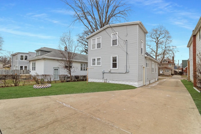 rear view of property with a lawn