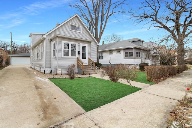 view of front of property featuring a front yard, a garage, and an outdoor structure