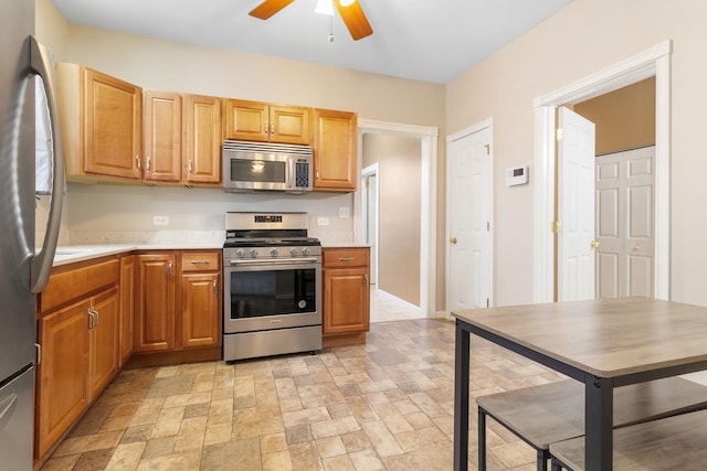 kitchen with ceiling fan and appliances with stainless steel finishes