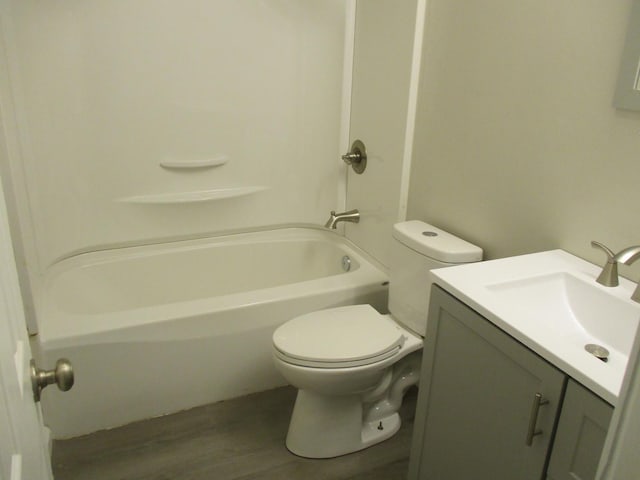 bathroom featuring shower / tub combination, vanity, toilet, and wood finished floors