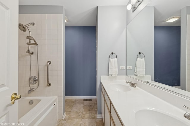 bathroom with vanity and tiled shower / bath