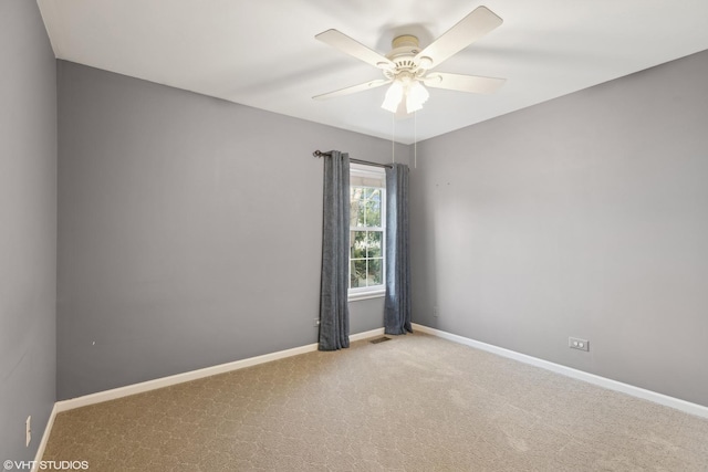 unfurnished room with ceiling fan and light colored carpet