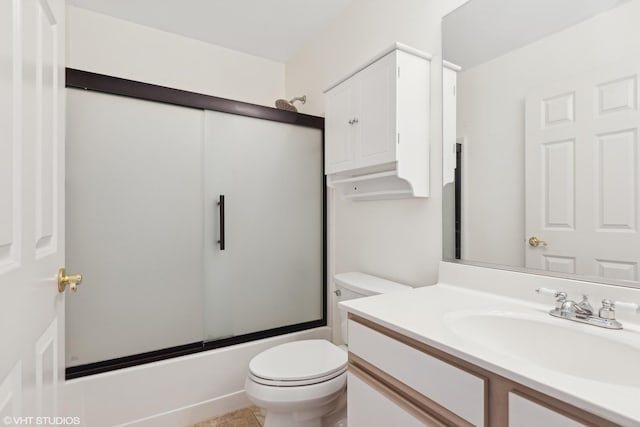 full bathroom featuring vanity, toilet, and bath / shower combo with glass door