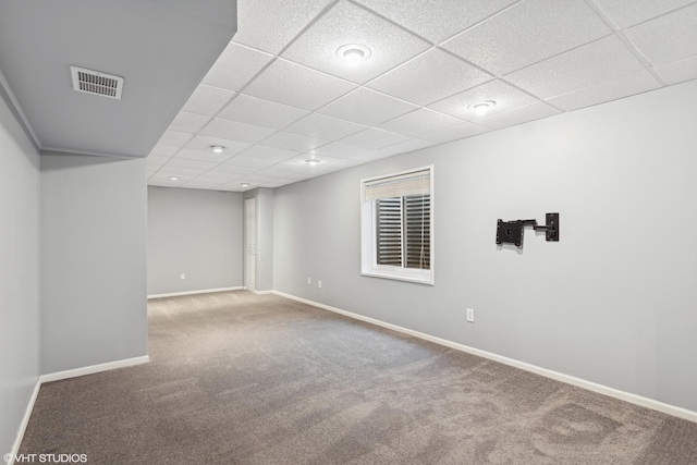 basement featuring carpet floors and a drop ceiling