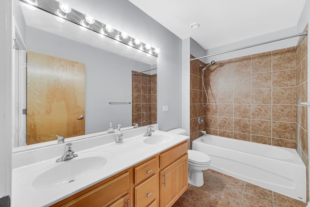 full bathroom with vanity, tiled shower / bath combo, tile patterned floors, and toilet