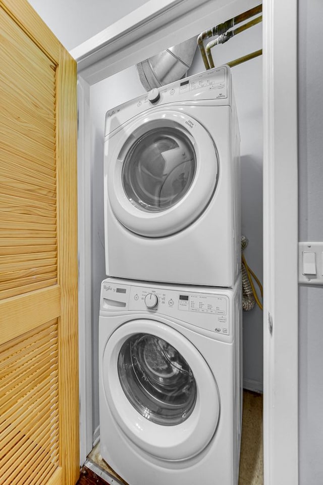 clothes washing area with stacked washer / drying machine