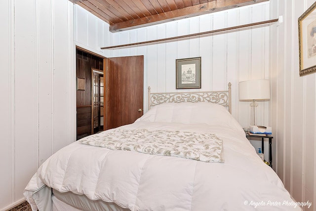 bedroom featuring wooden walls, a closet, and wooden ceiling