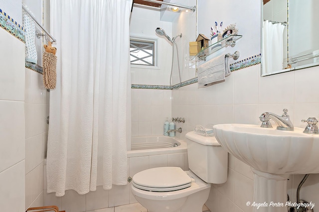 bathroom featuring toilet, tile walls, and shower / bath combo with shower curtain