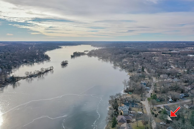 aerial view at dusk featuring a water view