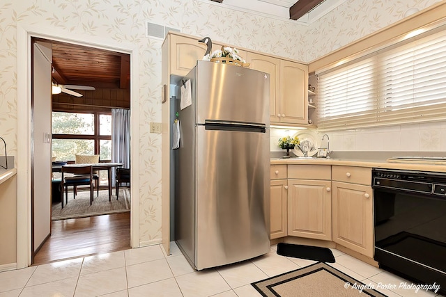 kitchen featuring stainless steel fridge, light tile patterned floors, ceiling fan, and light brown cabinetry