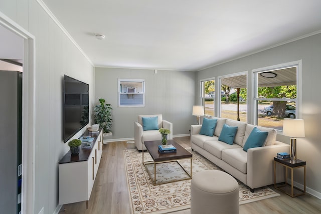 living room with light hardwood / wood-style floors and ornamental molding