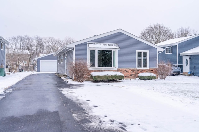 view of front of property featuring an outbuilding and a garage