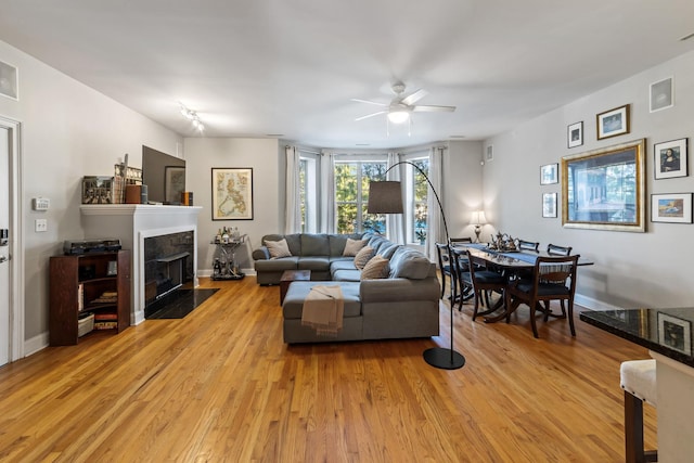 living room with ceiling fan and light hardwood / wood-style floors