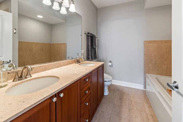 bathroom with tile patterned floors, vanity, toilet, and a bath