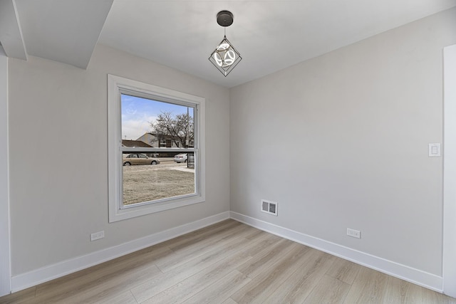 unfurnished dining area featuring light wood-type flooring